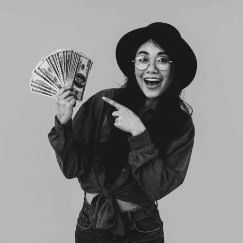 Black and white image of an Asian girl holding money, symbolizing affordable web development for small businesses.